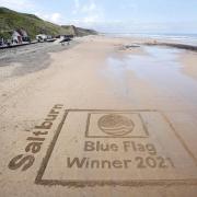The 'Blue Flag Award' sand etching at Saltburn. Photograph by Stuart Boulton.