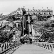 The pier was opened in 1869 and this picture shows the original octagonal houses on the prom. Behind the pair of houses is the cliff lift, which opened in June 1884