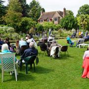 People picnicing on the lawns at Tudor Croft to listen to Charlotte Potter