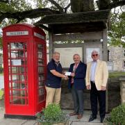 Richmond Rotary President Jos Huddleston (centre) presenting a cheque for £400 to John Hutchinson, Chairman of Bellerby Council (left) with Rotary organiser David Stewart