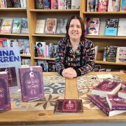 Jenna Warren at Guisborough Bookshop with copies of her debut novel