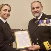 Petty Officer Holly Sadler receives her reward from Rear Admiral Steve Moorhouse