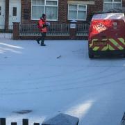A postie doing his round in a street near Cemetery Road in York