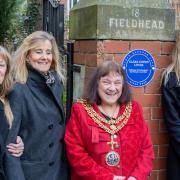 Cllr Jan Cossins and members of the Bradshaw family, Kate, Sam and Viveca, and the plaque dedicated to Clara Lucas