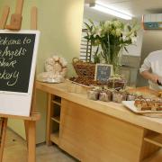 WARM WELCOME: Alex Franks serves customers at the Angel’s Share